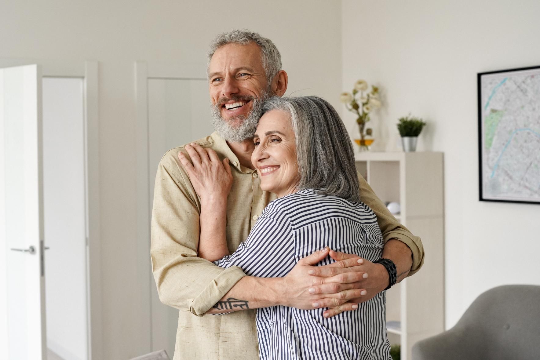 Two people embracing at home