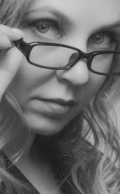 Woman holding her eyeglasses