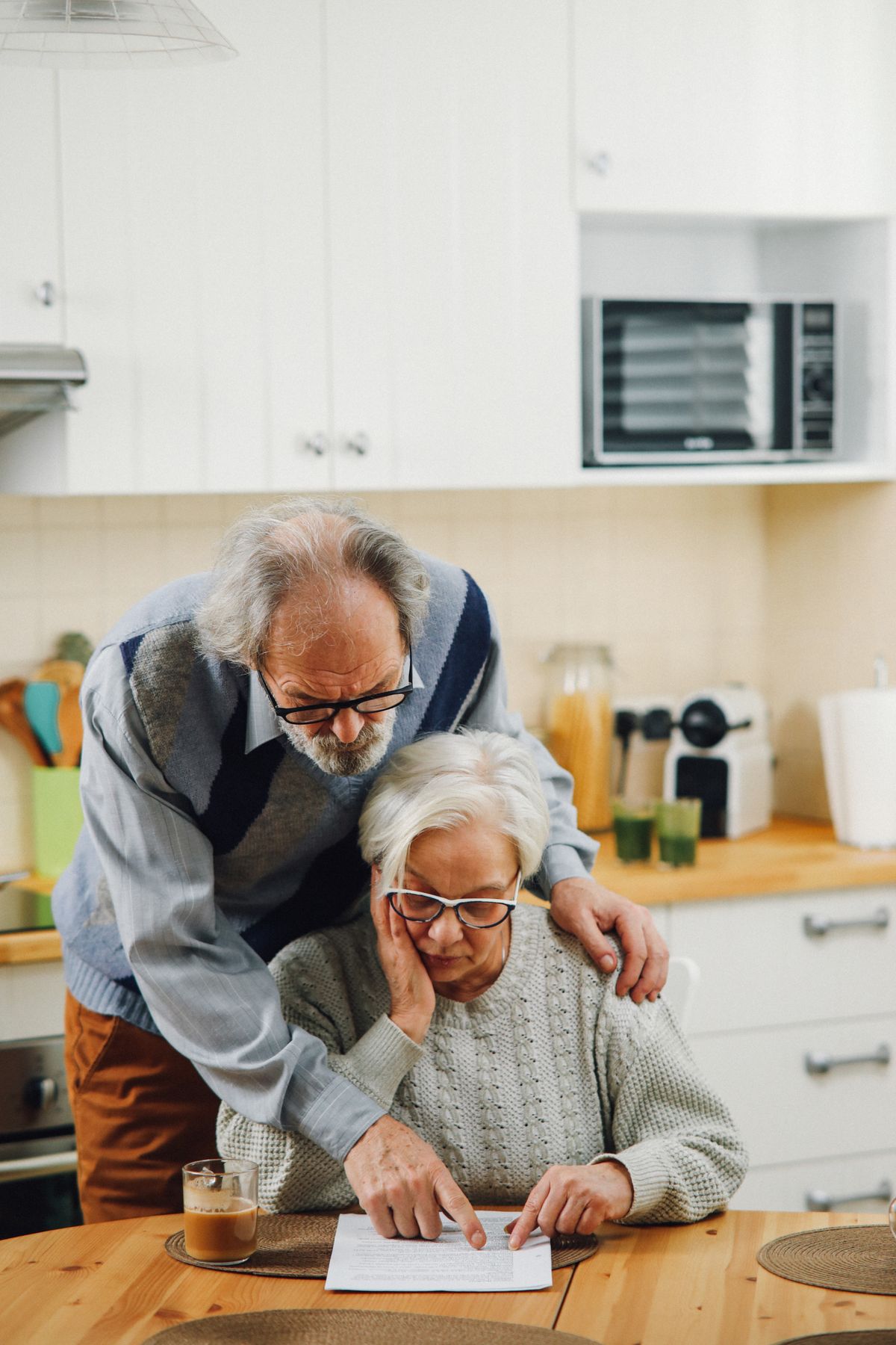 Senior couple reviewing documents together at home